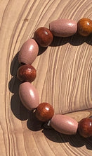 Load image into Gallery viewer, Handmade beaded bracelet on elastic. Made out dusty pink, brown and beige recycled beads.
