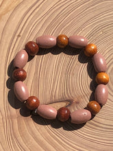 Load image into Gallery viewer, Handmade beaded bracelet on elastic. Made out dusty pink, brown and beige recycled beads.
