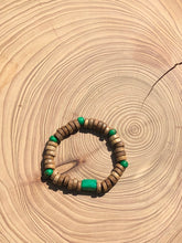 Load image into Gallery viewer, Handmade beaded bracelet on elastic. Made out of emerald green and brown recycled beads.
