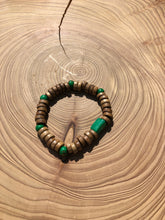 Load image into Gallery viewer, Handmade beaded bracelet on elastic. Made out of emerald green and brown recycled beads.
