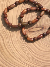 Load image into Gallery viewer, Handmade beaded bracelet on elastic. Made out of brown recycled beads.
