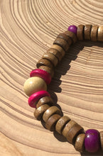 Load image into Gallery viewer, Handmade beaded bracelet on elastic. Made out hot pink, purple, brown and beige recycled beads.
