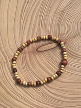 Load image into Gallery viewer, Handmade beaded bracelet on elastic. Made out of delicate small wooden recycled beads.
