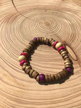 Load image into Gallery viewer, Handmade beaded bracelet on elastic. Made out hot pink, purple, brown and beige recycled beads.
