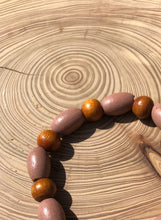 Load image into Gallery viewer, Handmade beaded bracelet on elastic. Made out dusty pink, brown and beige recycled beads.
