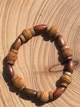 Load image into Gallery viewer, Handmade beaded bracelet on elastic. Made out of brown and beige textured recycled beads.
