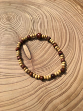 Load image into Gallery viewer, Handmade beaded bracelet on elastic. Made out of delicate small wooden recycled beads.
