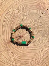 Load image into Gallery viewer, Handmade beaded bracelet on elastic. Made out of emerald green and brown recycled beads.
