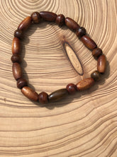 Load image into Gallery viewer, Handmade beaded bracelet on elastic. Made out of brown recycled beads.
