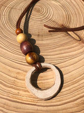 Load image into Gallery viewer, Hand made boho style necklace with hand carved pendant and vintage beads. On faux suede cord with tie fastening
