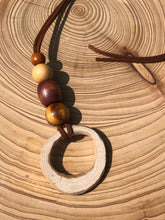 Load image into Gallery viewer, Hand made boho style necklace with hand carved pendant and vintage beads. On faux suede cord with tie fastening
