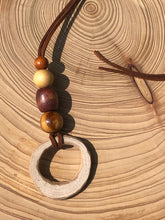 Load image into Gallery viewer, Hand made boho style necklace with hand carved pendant and vintage beads. On faux suede cord with tie fastening
