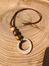 Load image into Gallery viewer, Hand made boho style necklace with hand carved pendant and vintage beads. On faux suede cord with tie fastening
