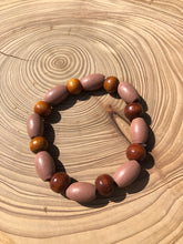 Load image into Gallery viewer, Handmade beaded bracelet on elastic. Made out dusty pink, brown and beige recycled beads.
