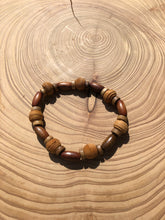 Load image into Gallery viewer, Handmade beaded bracelet on elastic. Made out of brown and beige textured recycled beads.
