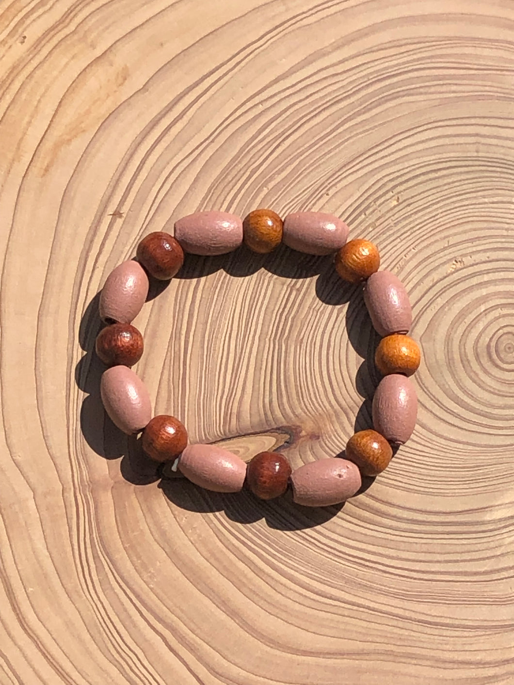 Handmade beaded bracelet on elastic. Made out dusty pink, brown and beige recycled beads.