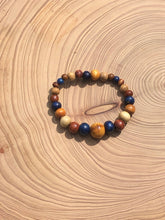 Load image into Gallery viewer, handmade beaded bracelet on elastic. Made out blue, brown and beige recycled beads.
