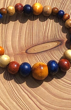 Load image into Gallery viewer, handmade beaded bracelet on elastic. Made out blue, brown and beige recycled beads.
