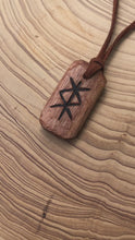 Load and play video in Gallery viewer, Protection Bind Rune hand carved amulet pendant necklace. Handmade from hardwood with detail added using pyrography.
