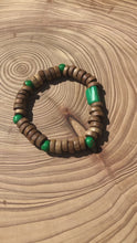 Load and play video in Gallery viewer, Handmade beaded bracelet on elastic. Made out of emerald green and brown recycled beads.
