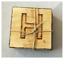 Load image into Gallery viewer, Wooden coaster set, the word &quot;home&quot; added with the pyrography technique.
